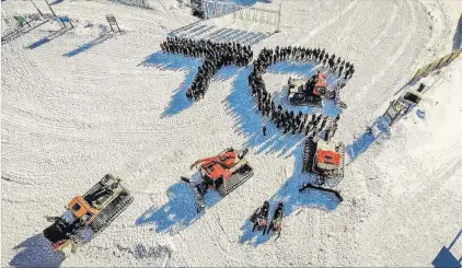  ?? PHOTO: DANNY WARLEY ?? Mark of respect . . . Cardrona Alpine Resort staff form the shape of the initials of colleague Tom Campbell, who was killed in a crash on the West Coast on Wednesday.