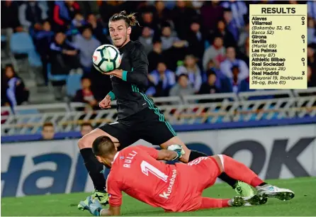  ??  ?? Real Madrid’s Gareth Bale scores in their La Liga match against Real Sociedad at the Anoeta Stadium in San Sebastian in Sunday. Madrid won 3-1.