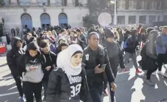  ??  ?? 0 Students walk out in the Brooklyn borough of New York