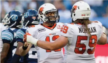  ?? CP FILE PHOTO ?? B.C. Lions’ Mike Reilly celebrates a touch down with Matt Norman during a game against the Toronto Argonauts in August. The Lions will face the Stampeders in the Grey Cup game on Sunday.