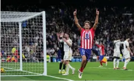  ?? ?? Atlético’s Marcos Llorente celebrates after scoring the 93rd-minute equaliser against Real Madrid, who had held the lead since the 20th minute. Photograph: Bernat Armangué/AP