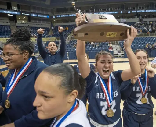  ?? Steph Chambers/Post-Gazette ?? Rochester’s Mia Anthony lifts the trophy after the Rams defeated West Greene in the WPIAL girls Class 1A championsh­ip game Friday at Petersen Events Center.