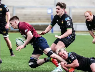  ?? ?? Angus Keys is hauled down by a Ballymena player.