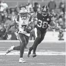  ?? ?? Patriots receiver JuJu Smith-Schuster (7) runs after a catch as Pittsburgh Steelers linebacker Mykal Walker chases during the second quarter at Acrisure Stadium.