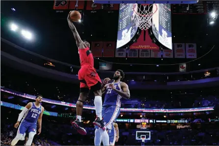  ?? The Associated Press ?? Toronto Raptors’ OG Anunoby goes for a dunk against Philadelph­ia 76ers’ Joel Embiid during Game 5 of their NBA playoff series, Monday, in Philadelph­ia.