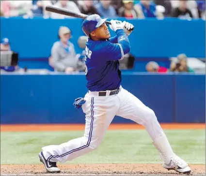  ?? — REUTERS ?? Toronto Blue Jays shortstop Yunel Escobar hits a triple to drive in three runs during the fourth inning of their American League game against the Texas Rangers in Toronto on Wednesday.