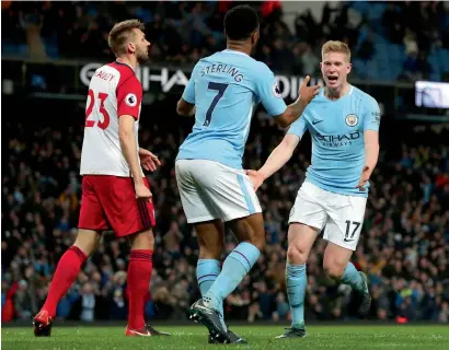  ??  ?? Kevin De Bruyne (right) celebrates with Raheem Sterling after scoring a goal against West Bromwich during a Premier League match. —