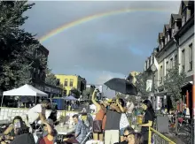  ?? CLIFFORD SKARSTEDT/EXAMINER FILES ?? A rainbow frames people taking part in the annual Hootenanny on Hunter event organized by Downtown Business Improvemen­t Area on Aug. 12 on Hunter St. The street was hopping with live music, fun fair, skateboard expo, DJs, sidewalk sales, food vendors...