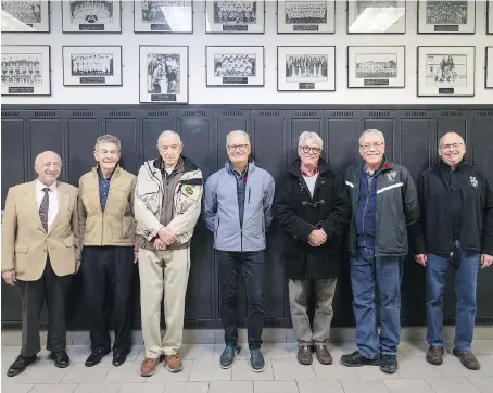  ?? DAX MELMER/WINDSOR STAR ?? Assumption Catholic High School alumni, from left, Edward Alice, Frank Chick and Phillip Milan, from the class of 1948, and Drew Mathany, Charles West, John Lesperance and Bob Carter, from the class of 1968, are pictured in the hallway of the school before attending the 50th and 70th reunions of the school on Saturday.