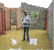  ?? Picture: SIMPHIWE NKWALI ?? UNFINISHED: Joseph Ntombela of Bloemside township Phase 4 stands inside his incomplete house