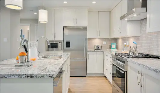  ??  ?? Granite countertop­s and built-in stainless-steel appliances are featured in the kitchens of Tsawwassen Springs condos that start at $399,000.