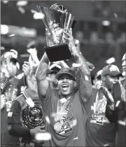  ?? MARK J. TERRILL / The Associated Press ?? USA’s Marcus Stroman holds up the World Baseball Classic Trophy after Wednesday’s game.