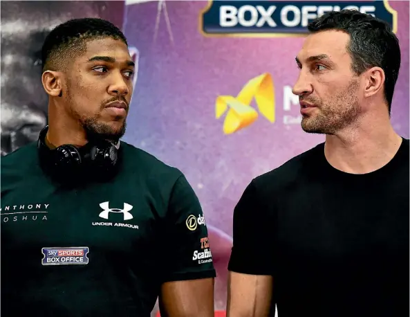  ??  ?? Briton Anthony Joshua, left, and Wladimir Klitschko, of Ukraine, fight for the IBF and WBA heavyweigh­t crowns in London on April 29.
