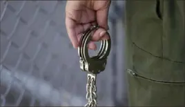  ?? Eric Risberg/Associated Press ?? A guard holds a pair of handcuffs in 2016, at San Quentin State Prison in California.