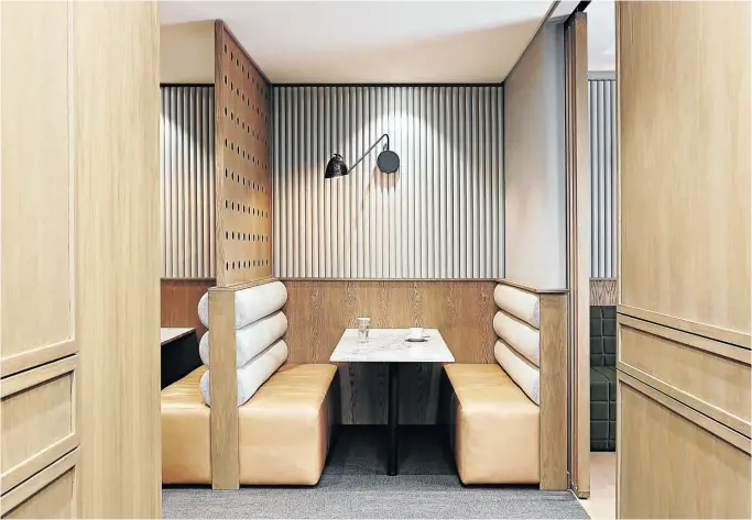  ??  ?? Meeting pods feature sophistica­ted wooden and upholstere­d panelling, and the Studio 19 Lian swing light