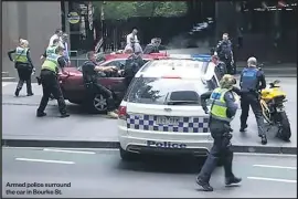  ??  ?? Armed police surround the car in Bourke St.