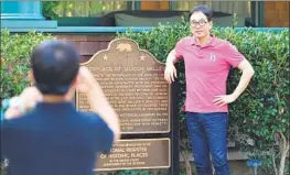  ??  ?? TOURIST Yungsam Kim poses at the Hewlett-Packard house in Palo Alto. Residents in just one ZIP Code there paid nearly $1 billion in state income tax in 2016.