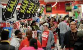  ?? Photograph: Erik S Lesser/EPA ?? Customers shop for sale items at a Target store open early for Black Friday in Atlanta, Georgia, in 2012.