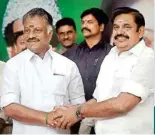  ??  ?? Tamil Nadu Chief Minister K Palaniswam­i (R) and O Panneersel­vam exchange greetings following merger of their factions in Chennai on Monday