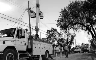  ??  ?? These Veridian Connection­s workers, along with 170 Hydro One employees, are the only Canadian crews helping restore power to hurricane-ravaged Florida where 6 million customers were in the dark.