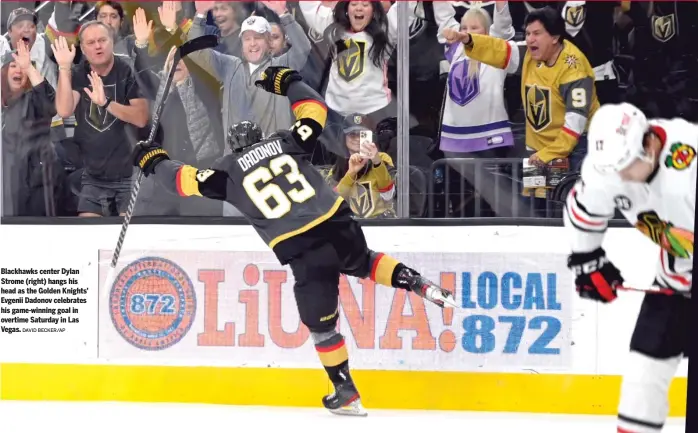  ?? DAVID BECKER/AP ?? Blackhawks center Dylan Strome (right) hangs his head as the Golden Knights’ Evgenii Dadonov celebrates his game-winning goal in overtime Saturday in Las Vegas.