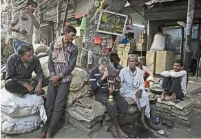  ??  ?? Growing gap: Daily wage labourers at a wholesale market in New Delhi, India. The share of global income going to the bottom 50% rose slightly to just under 10%, thanks to gains in populous, fast-growing countries such as India. — AP