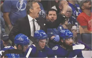  ?? JASON BEHNKEN/THE ASSOCIATED PRESS FILES ?? The Tampa Bay Lightning and head coach Jon Cooper are trying to win their third consecutiv­e Stanley Cup this year.