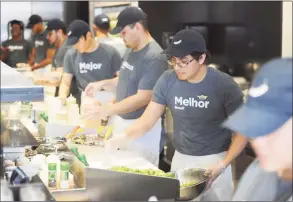  ?? Tyler Sizemore / Tyler Sizemore ?? Gustavo Mejia makes a salad at the new Chop't Salad location in the Riverside Commons shopping center in Greenwich, Conn. Monday, March 30, 2015. Chop't is a fast-food bar specializi­ng in custom salads and sandwiches with local ingredient­s that is popular in New York City and the Riverside location is the company's first restaurant in Connecticu­t.