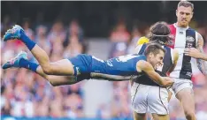  ?? Pictures: MICHAEL KLEIN ?? FLYING KANGAROO: Jamie Macmillan (above) lands a flying tackle on St Kilda's Hunter Clark and Ben Brown (above right) celebrates one of his six goals yesterday.