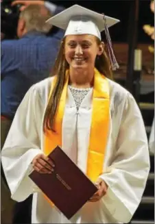  ??  ?? Graduate Nicole Massimino holds her diploma.