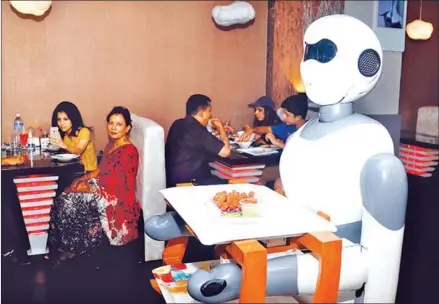  ?? KESHAV THAPA/THE KATHMANDU POST ?? Ginger, the robot server, delivers a customer’s order at Naulo Restaurant in Durbarmarg, Kathmandu.