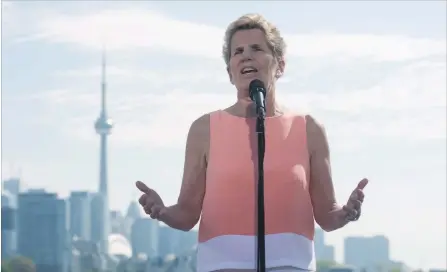  ?? MARTA IWANEK THE CANADIAN PRESS ?? Ontario Liberal Leader Kathleen Wynne speaks to reporters at Ontario Place in Toronto on Friday.