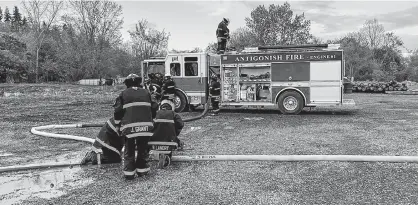  ?? CONTRIBUTE­D ?? Members of the Antigonish Town Fire Department ready their equipment during a training exercise.