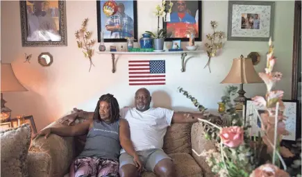  ?? BRONTE WITTPENN/USA TODAY NETWORK ?? Maritza Ambler and her husband, Javier Ambler, have a memorial wall dedicated to their son in the living room of their Killeen, Texas, home. “We need some closure,” Javier Ambler said. “And we want justice.”