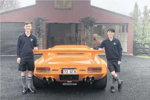  ?? PHOTO: SUPPLIED ?? Opening garage doors . . . Kings High School pupils Liam Ellwood (left) and Sam Larsen with one of the muscle cars that will be part of next Saturday’s Garage Raid fundraiser.