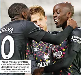  ?? PAUL HARDING/GETTY IMAGES ?? Yoane Wissa of Brentford celebrates with team-mate Josh Dasilva after scoring the Bees’ second goal