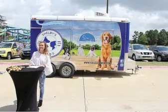  ?? Staff photo by Karl Richter ?? ■ Shelby Dunphy-Day speaks after the unveiling of the Texarkana Animal Care and Adoption Center’s new adoption trailer Tuesday at Arkansas Convention Center in Texarkana, Ark. Shelby’s P.A.W.S., the organizati­on she founded, raised $32,000 to pay for...