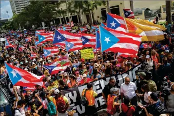  ?? ASSOCIATED PRESS ?? PEOPLE GATHER TO CELEBRATE THE RESIGNATIO­N OF GOV. RICARDO ROSSELLO who announced overnight that he is resigning Aug. 2 after weeks of protests over leaked obscene, misogynist­ic online chats, in San Juan, Puerto Rico, on Thursday.