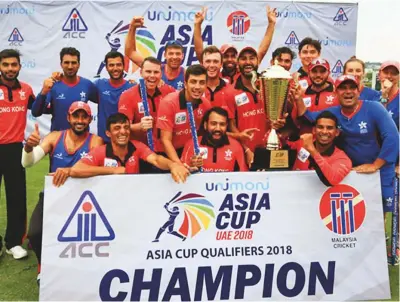  ?? Courtesy: ACC ?? The Hong Kong team celebrate with the Asia Cup Qualifiers trophy after defeating UAE in the final by two wickets at the Kinrara Oval in Malaysia yesterday.