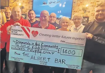  ?? ?? Gem of a gesture The Albert Bar’s cheque presentati­on to charity Diamonds in the Community