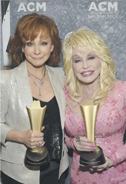  ?? RICK DIAMOND/GETTY IMAGES ?? Music legends Reba McEntire, left, and Dolly Parton attend the 11th annual Academy of Country Music Honors in Nashville Wednesday.