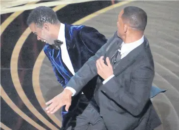  ?? ?? NO LAUGHING MATTER: Will Smith walks onstage and slaps Chris Rock at the 94th Academy Awards on March 27.