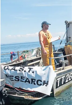  ??  ?? Diver Howard Wood and support team check progress in Arran’s No Take Zone, and the Seaspiracy logo, inset, top left