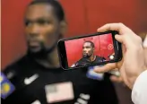  ?? John Locher / Associated Press 2018 ?? A reporter takes video of Kevin Durant during a training camp for USA basketball.