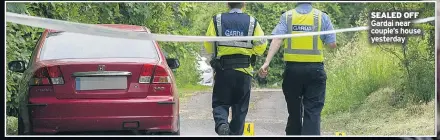  ??  ?? SEALED OFF Gardai near couple’s house yesterday