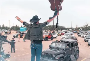  ?? BEN DARTNELL ?? Country star Brett Kissel hosted two days of outdoor concerts last weekend in the parking lot of Edmonton’s River and Cree Casino. The band performed on a stage fitted with Plexiglas barriers.