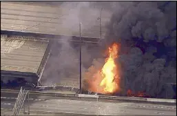  ?? AP ?? A large fire that caused an overpass on Interstate 85 to collapse burns in Atlanta on Thursday.