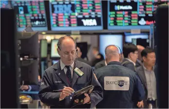  ?? BRYAN R. SMITH, AFP/GETTY IMAGES ?? Traders should temper their expectatio­ns for the New York Stock Exchange for the rest of 2017.