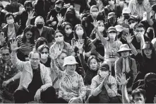  ?? Ng Han Guan / Associated Press ?? Protesters raise their hand to symbolize the five demands of the pro-democracy movement. They were at a rally for young and elderly pro-democracy demonstrat­ors Saturday in Hong Kong.