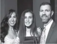  ??  ?? Fiona Fruitman, center, a 2016 debutante, stands with her parents, Belina and Alan.